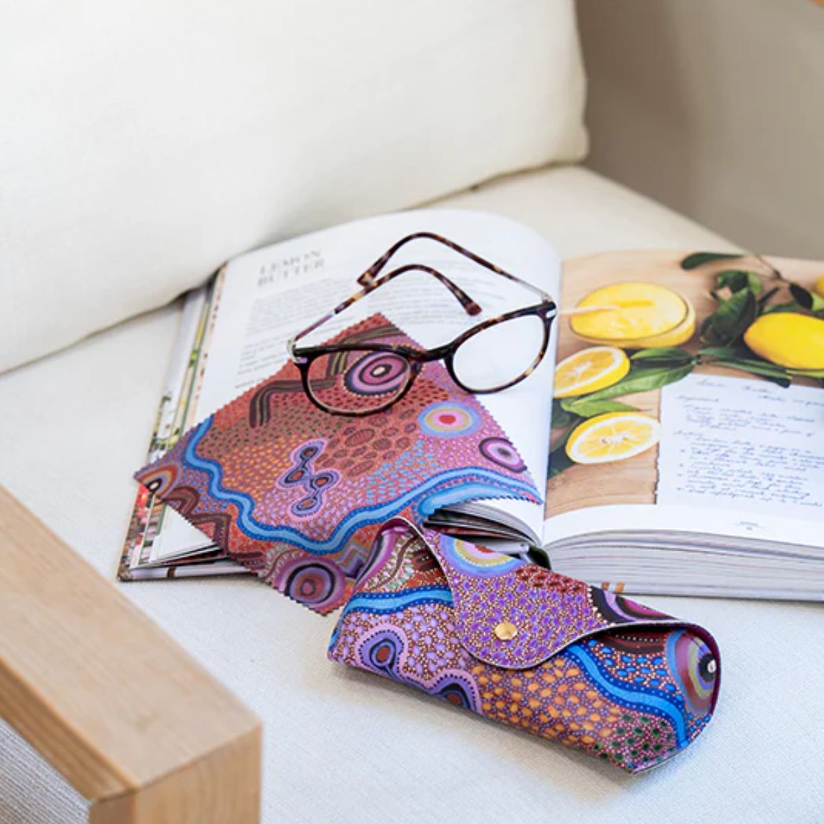Colorful patterned glasses case on an open book with lemon illustrations