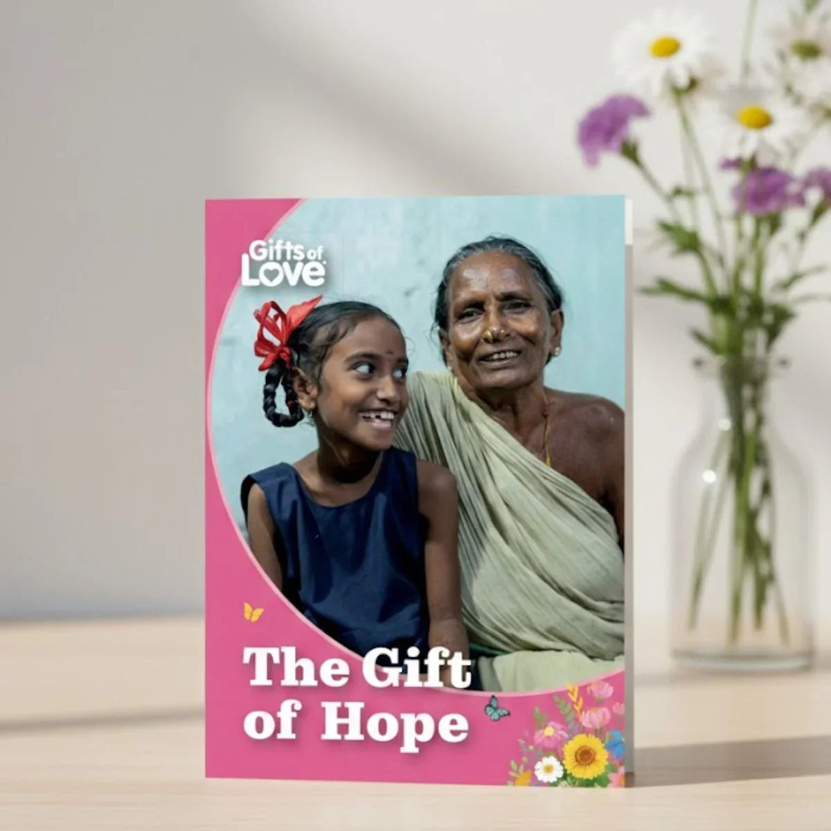 Card with a photo of a young girl and an older woman, titled 'The Gift of Hope', with a pink border.