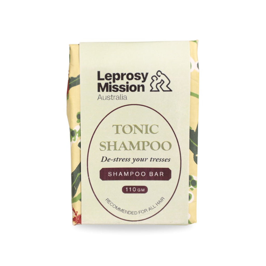 Leprosy Mission Australia Tonic Shampoo bar packaging, featuring a cream-colored front with dark brown text and botanical pattern borders on the sides.