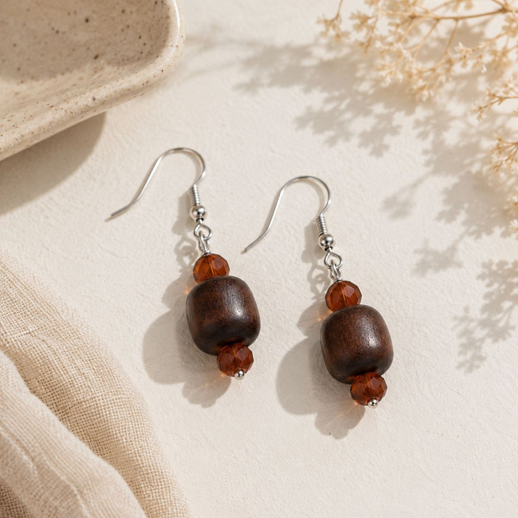 Pair of wooden bead earrings on a neutral background