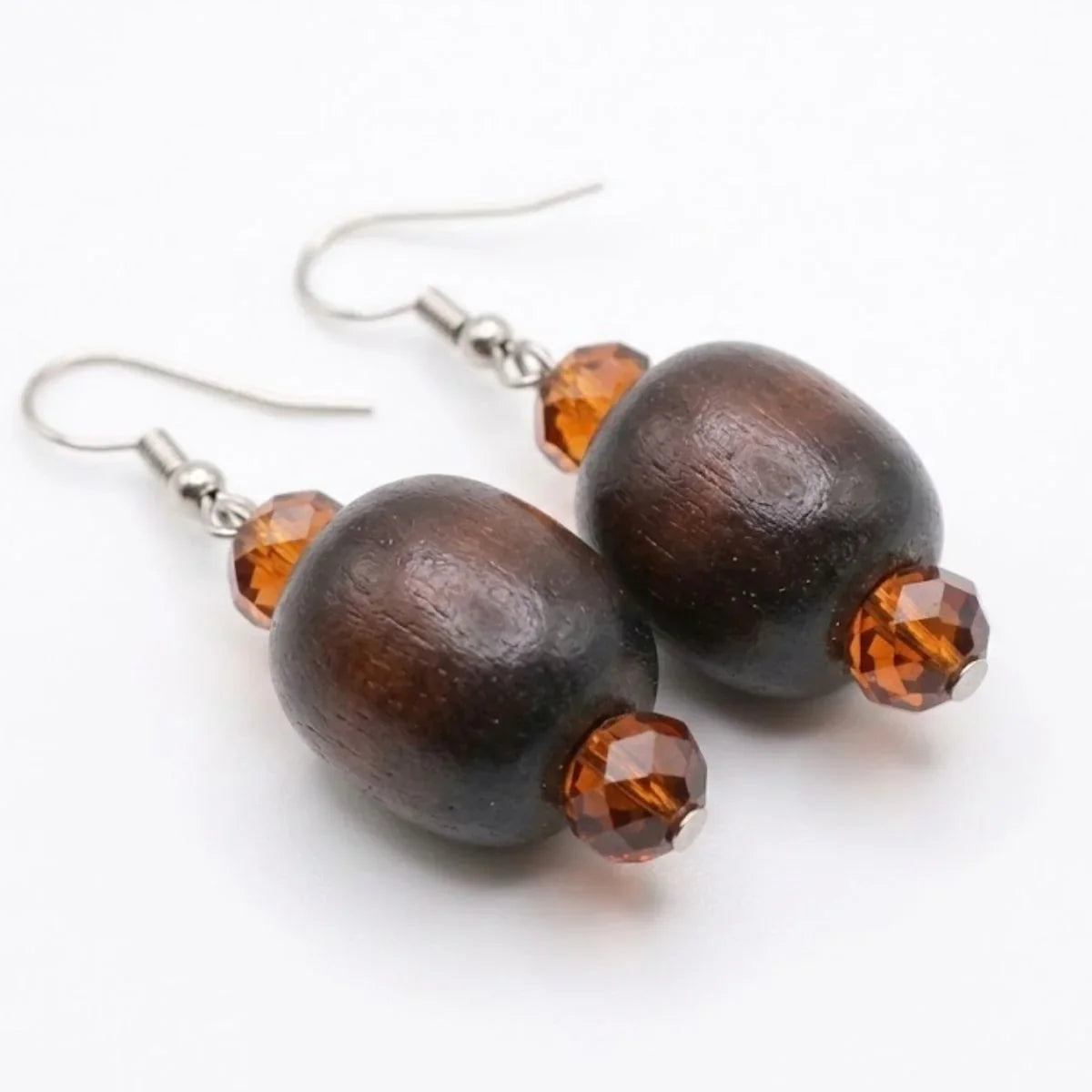 Wooden earrings with brown beads on a white background