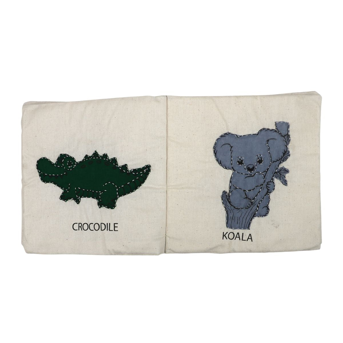 Book with embroidered illustrations of a crocodile and a koala on a white background