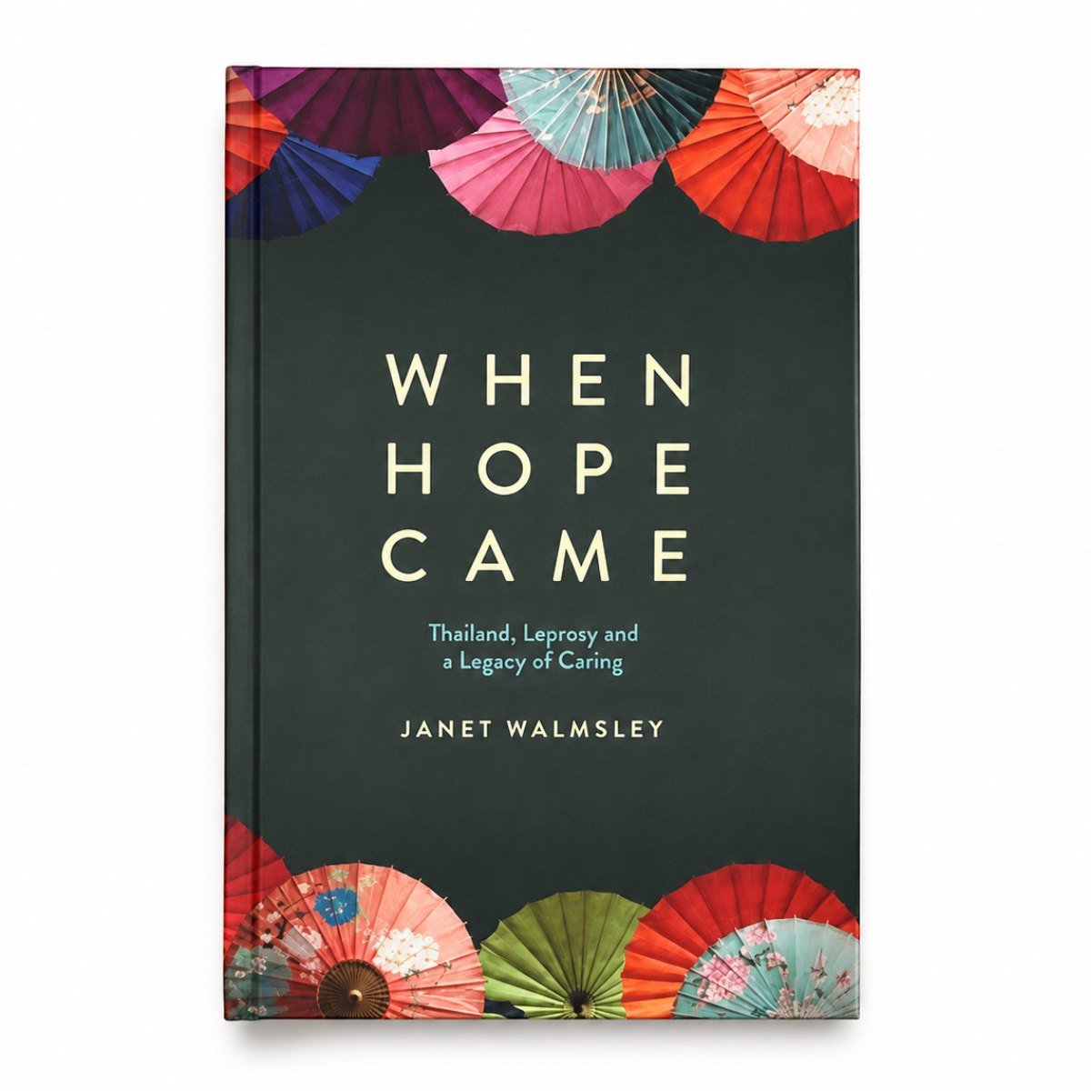 The book cover of 'When Hope Came' by Janet Walmsley, featuring a dark charcoal background with cream-colored title text and colorful traditional folding fans illustrated along the top and bottom borders.