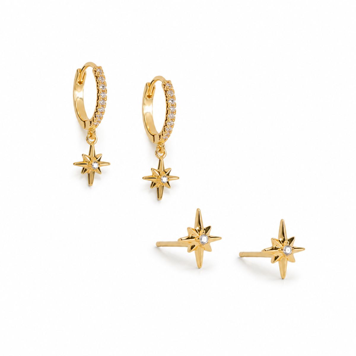 Set of gold star-shaped earrings on a white background