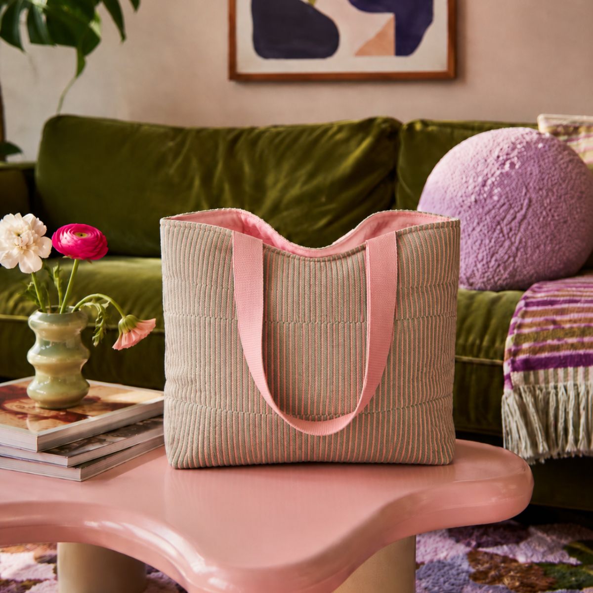 Tote bag with pink handles on a pink table in a living room setting