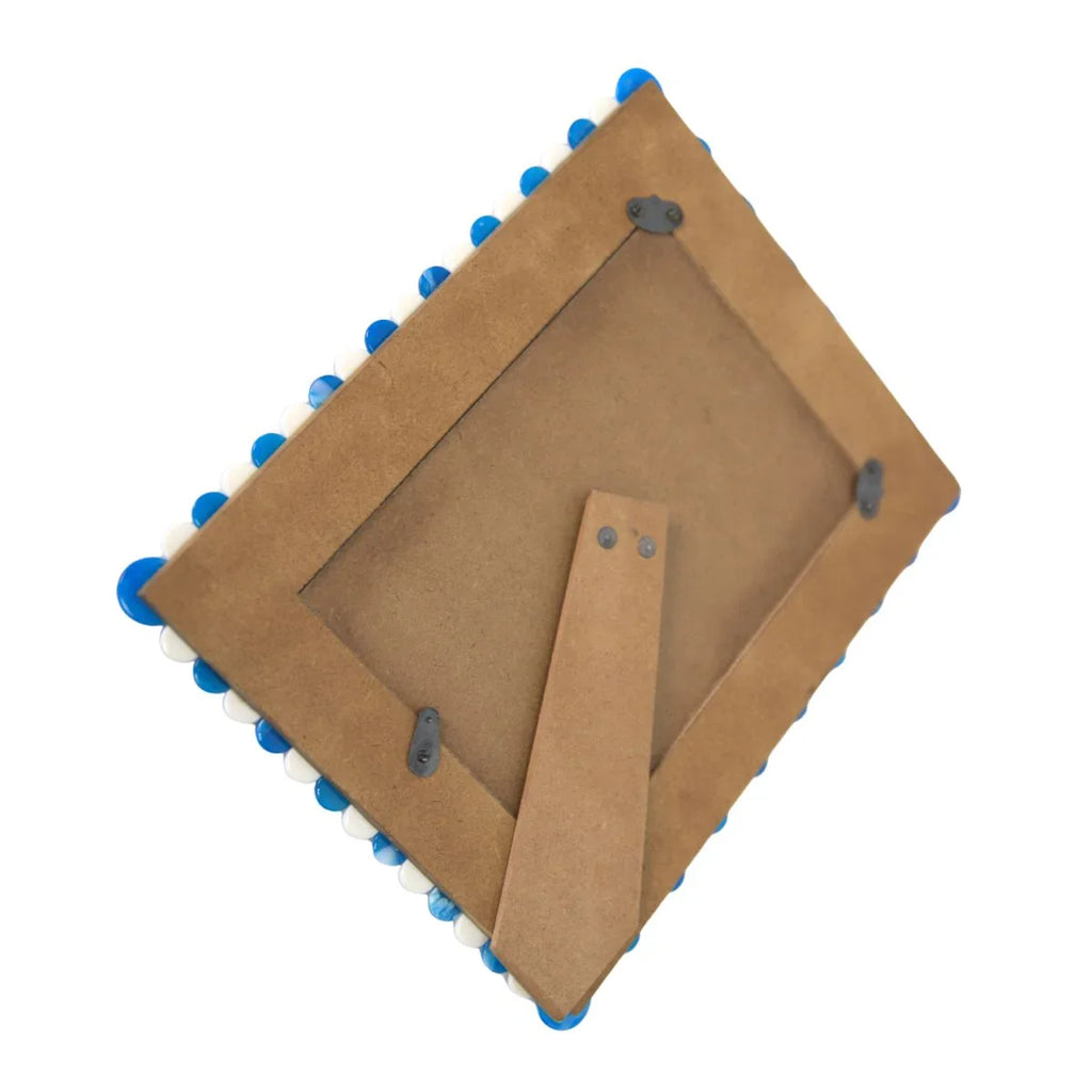 Cardboard square with blue and white circular cutouts on a white background