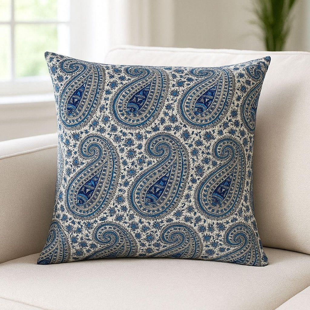 Blue paisley patterned pillow on a beige sofa