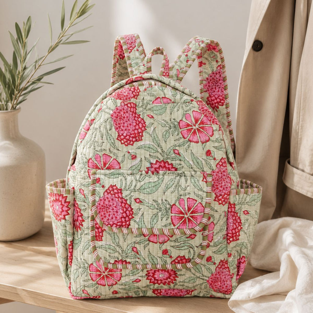 Floral patterned backpack on a wooden surface with a neutral background