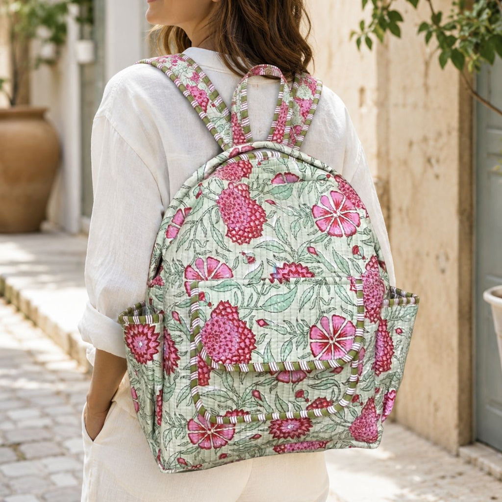 Person wearing a floral backpack outdoors