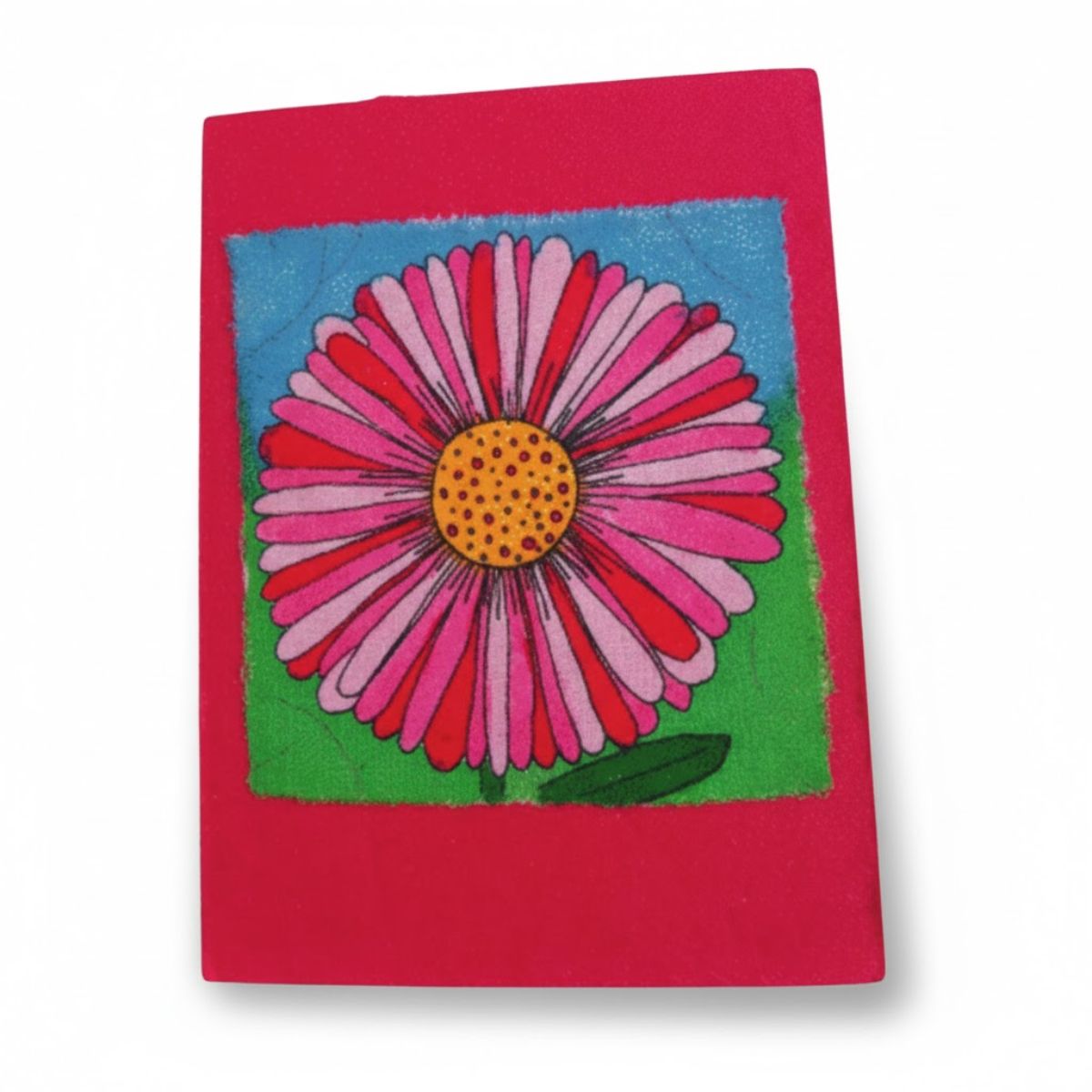 Notebook with a pink flower design on a red background