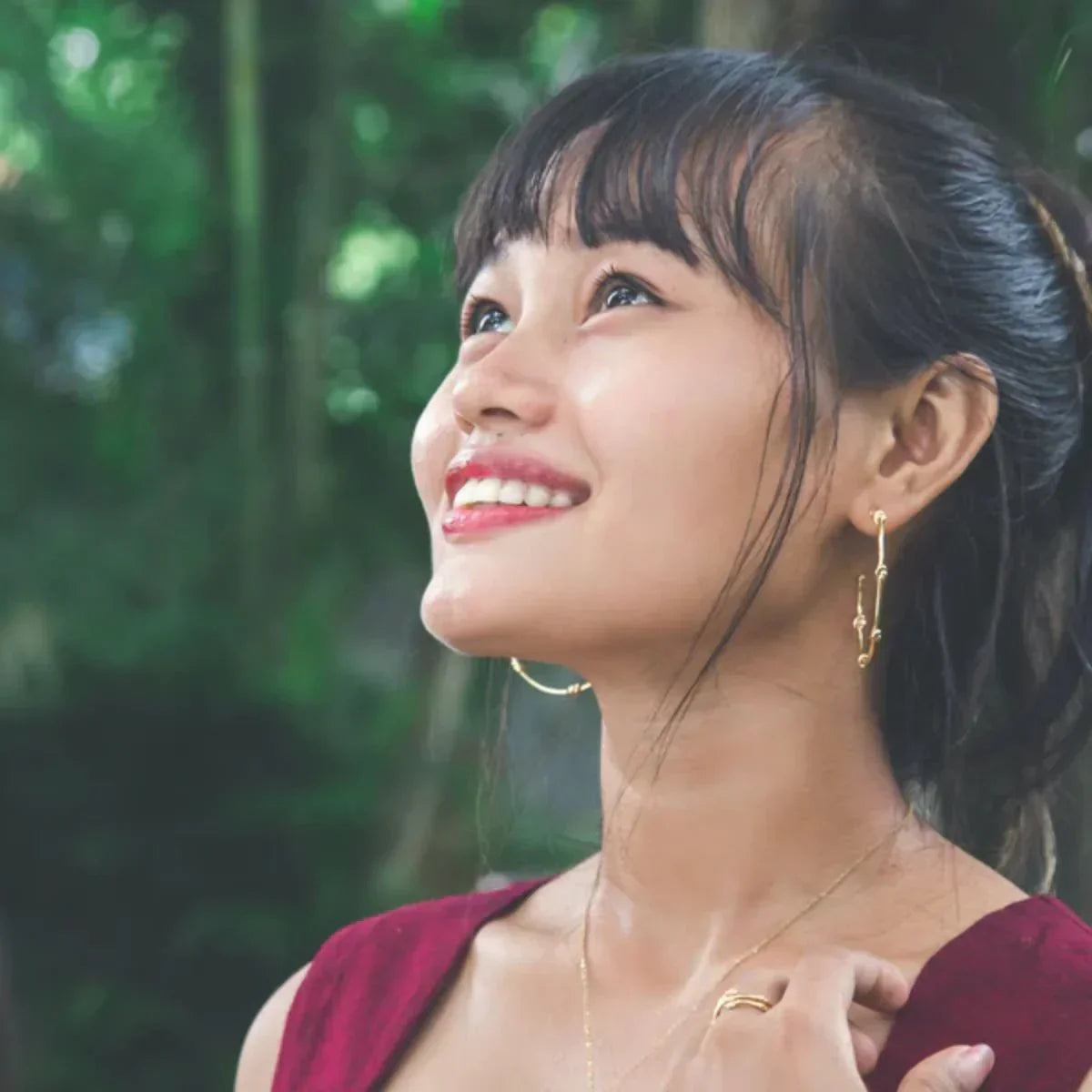 Woman with a smile against a green blurred background