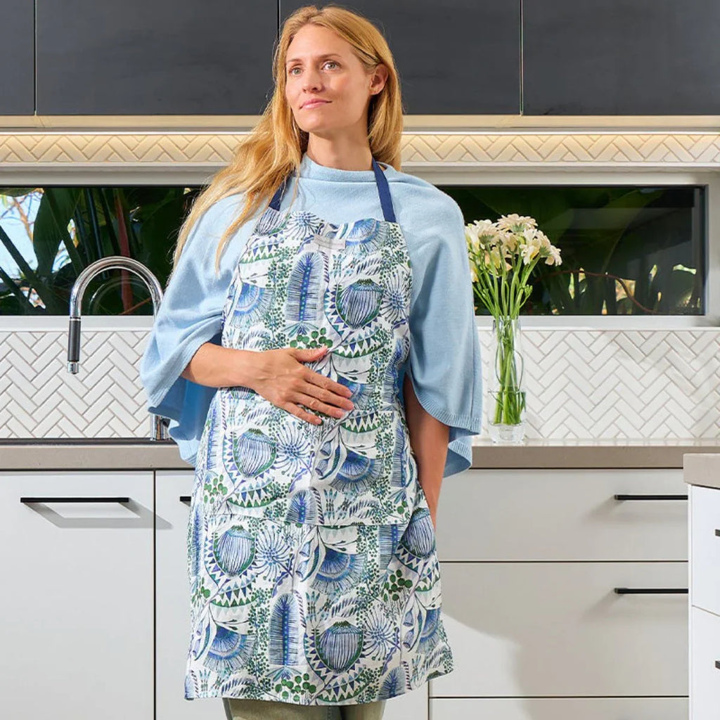 Woman wearing a patterned apron in a kitchen