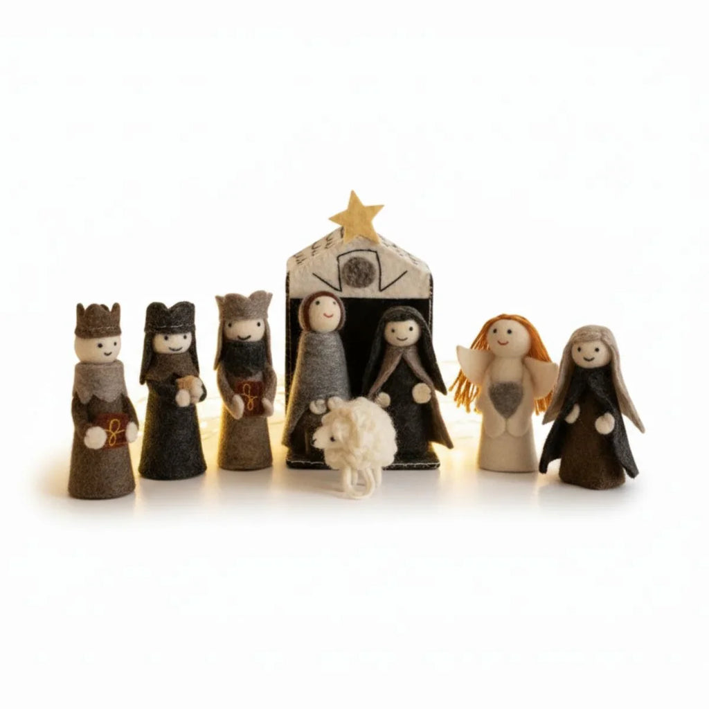 Miniature nativity scene with figures and stable on a white background