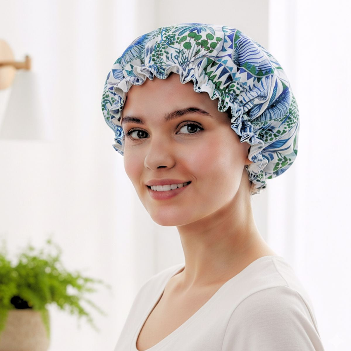 Woman wearing a floral-patterned shower cap indoors