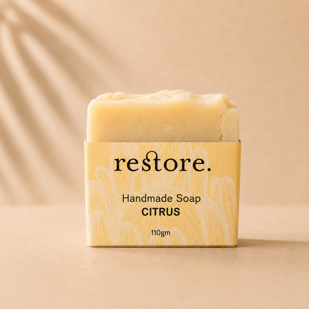 Handmade soap bar with 'restore' packaging on a beige background