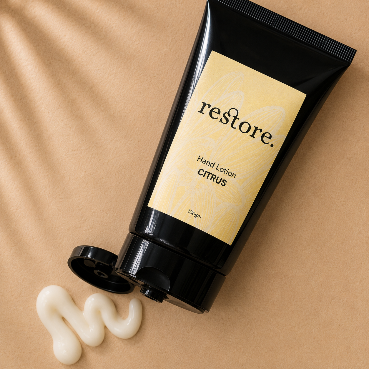Hand lotion tube labeled 'restore' on a beige background