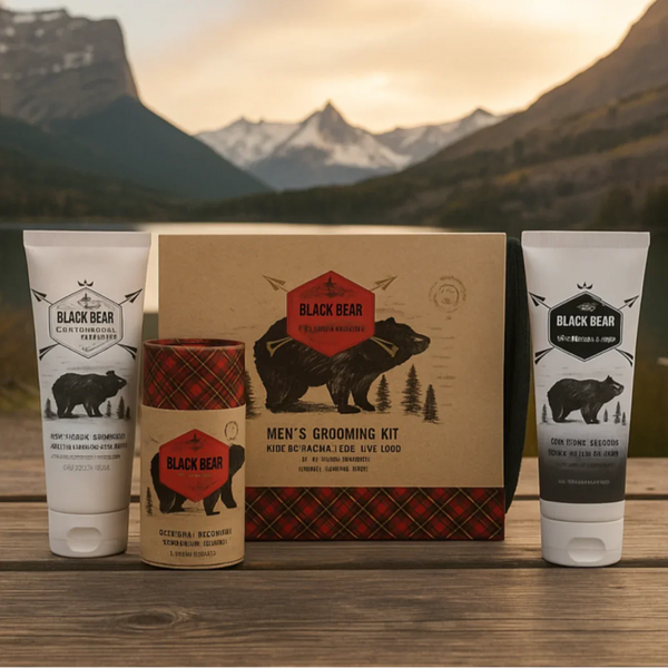 Men's grooming kit with Black Bear brand products against a mountainous landscape.