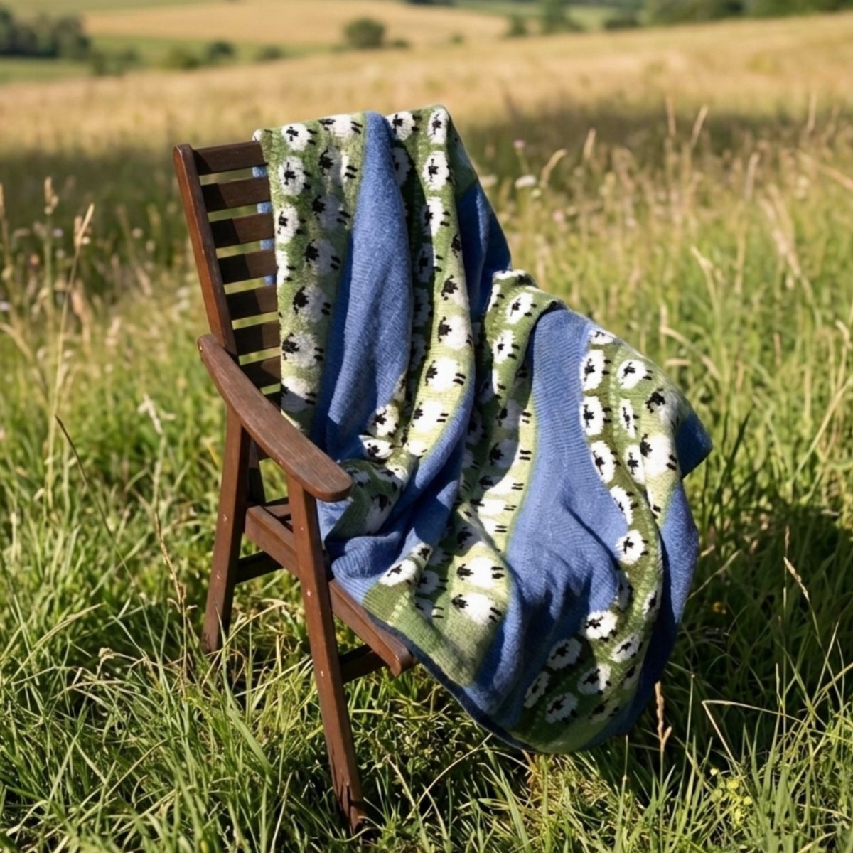 Blanket with animal pattern draped over a chair in a grassy field