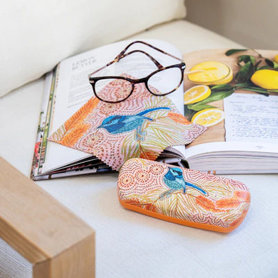 Colorful case with bird design on a magazine with a lemon illustration