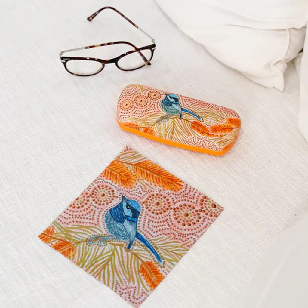 Colorful eyeglass case with bird design on a white surface