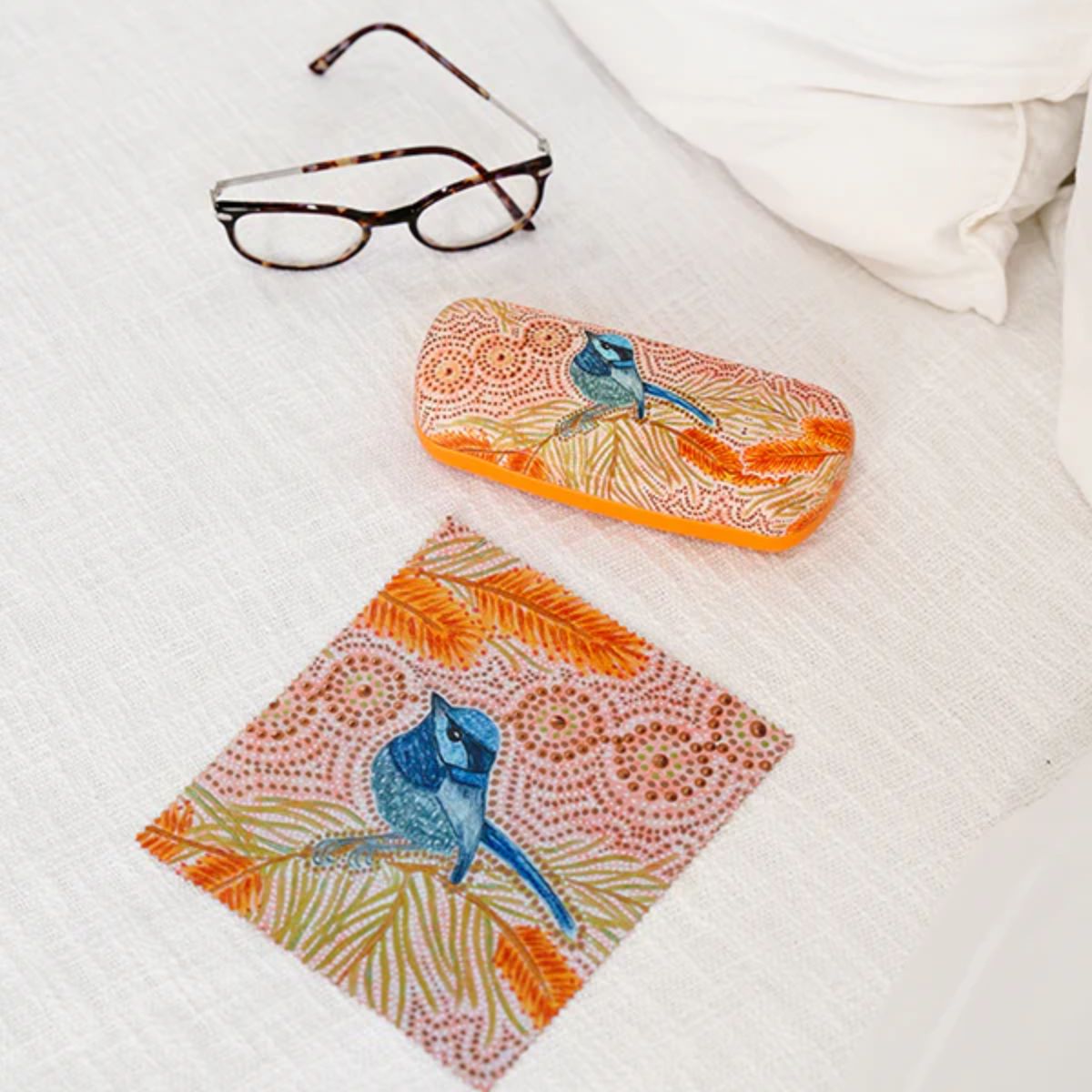 Colorful eyeglass case with bird design on a white surface
