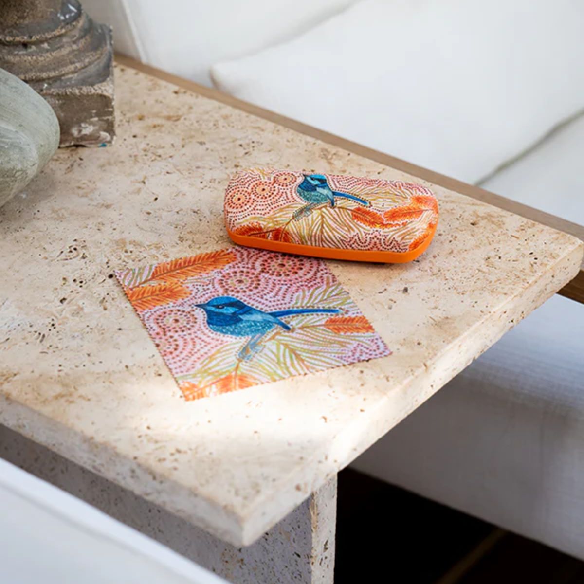 Colorful fabric with bird design on a stone surface