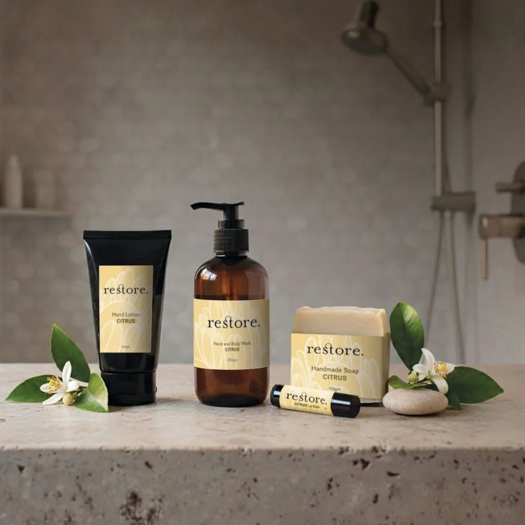 Bathroom setting with 'restore' skincare products on a concrete surface.