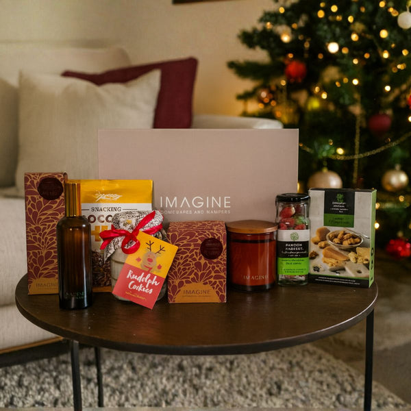 Assorted products on a table with a Christmas tree in the background
