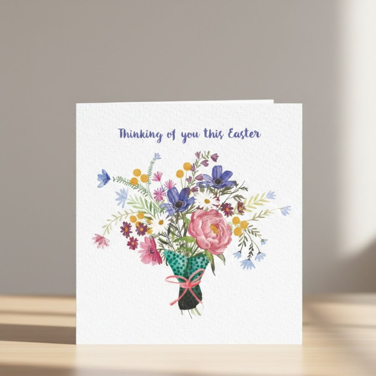 Greeting card with floral design and 'Thinking of you this Easter' text on a plain background