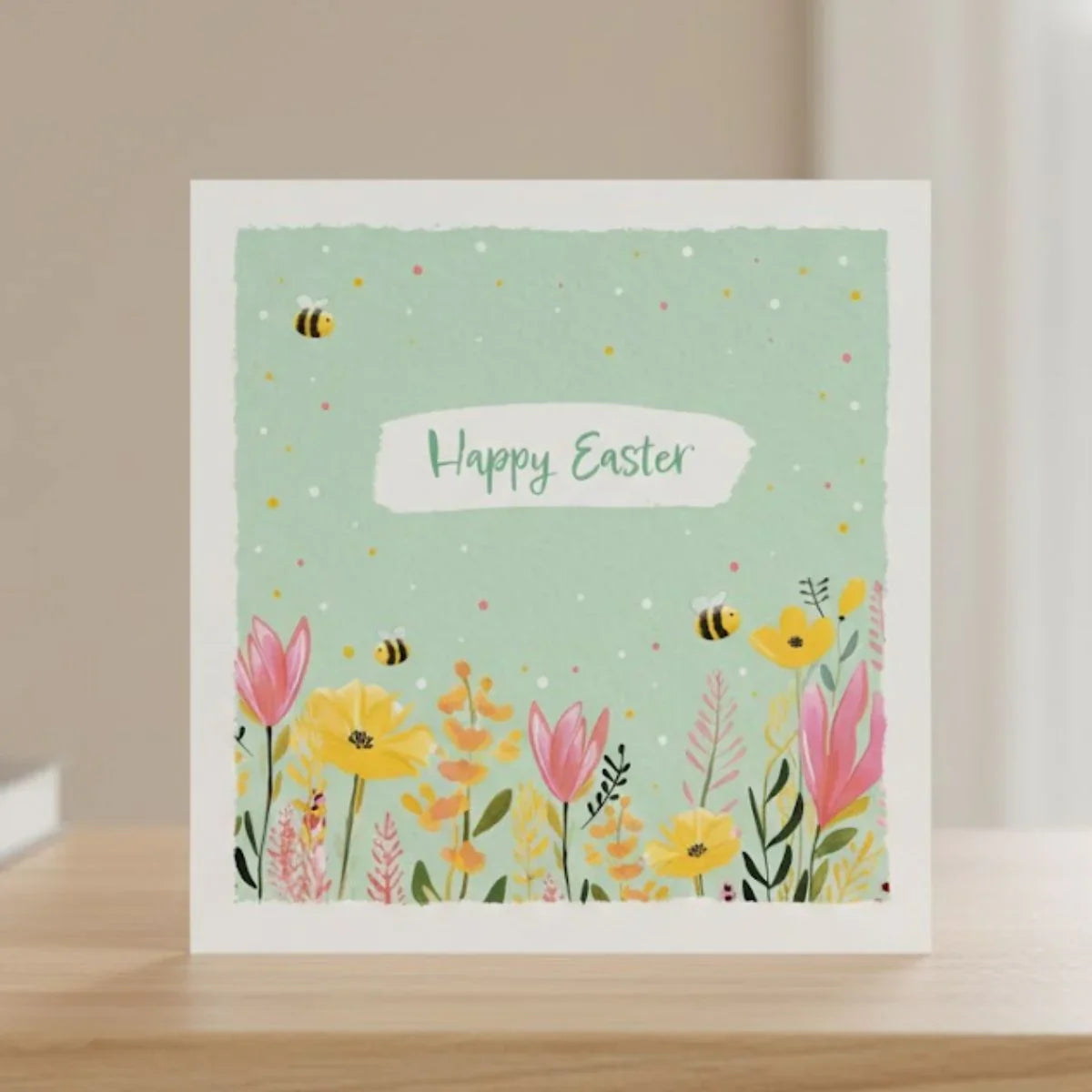 Greeting card with floral design and 'Happy Easter' text on a light green background.
