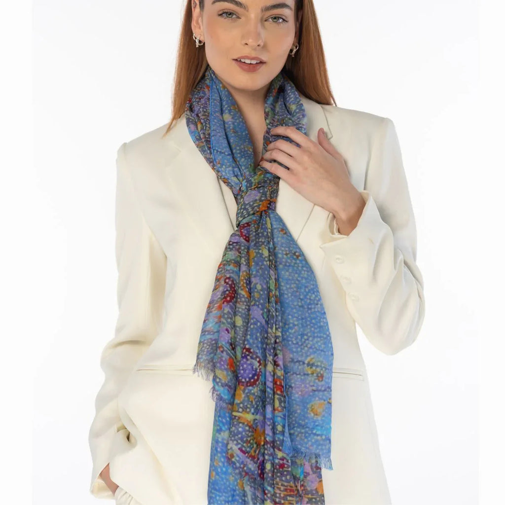 Woman wearing a colorful scarf with a white jacket on a white background