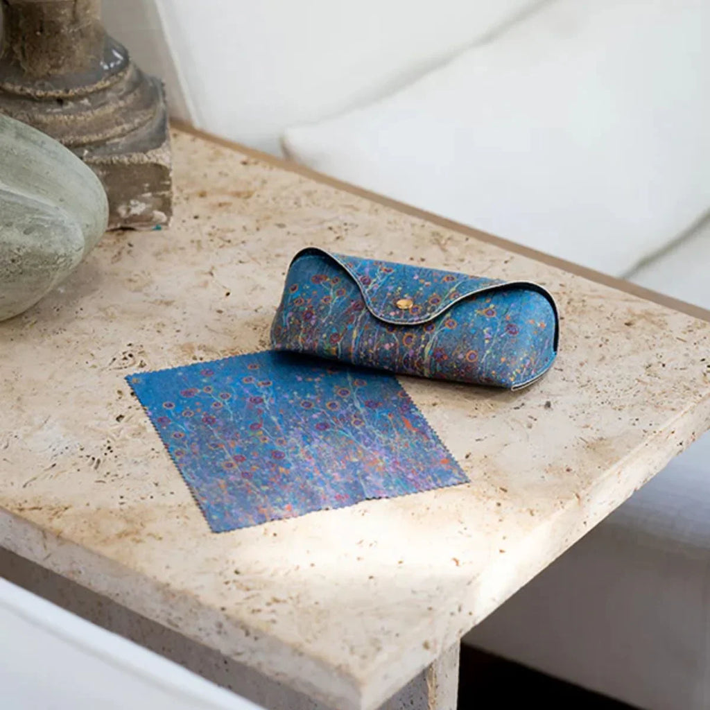 Blue patterned pouch and mat on a textured surface