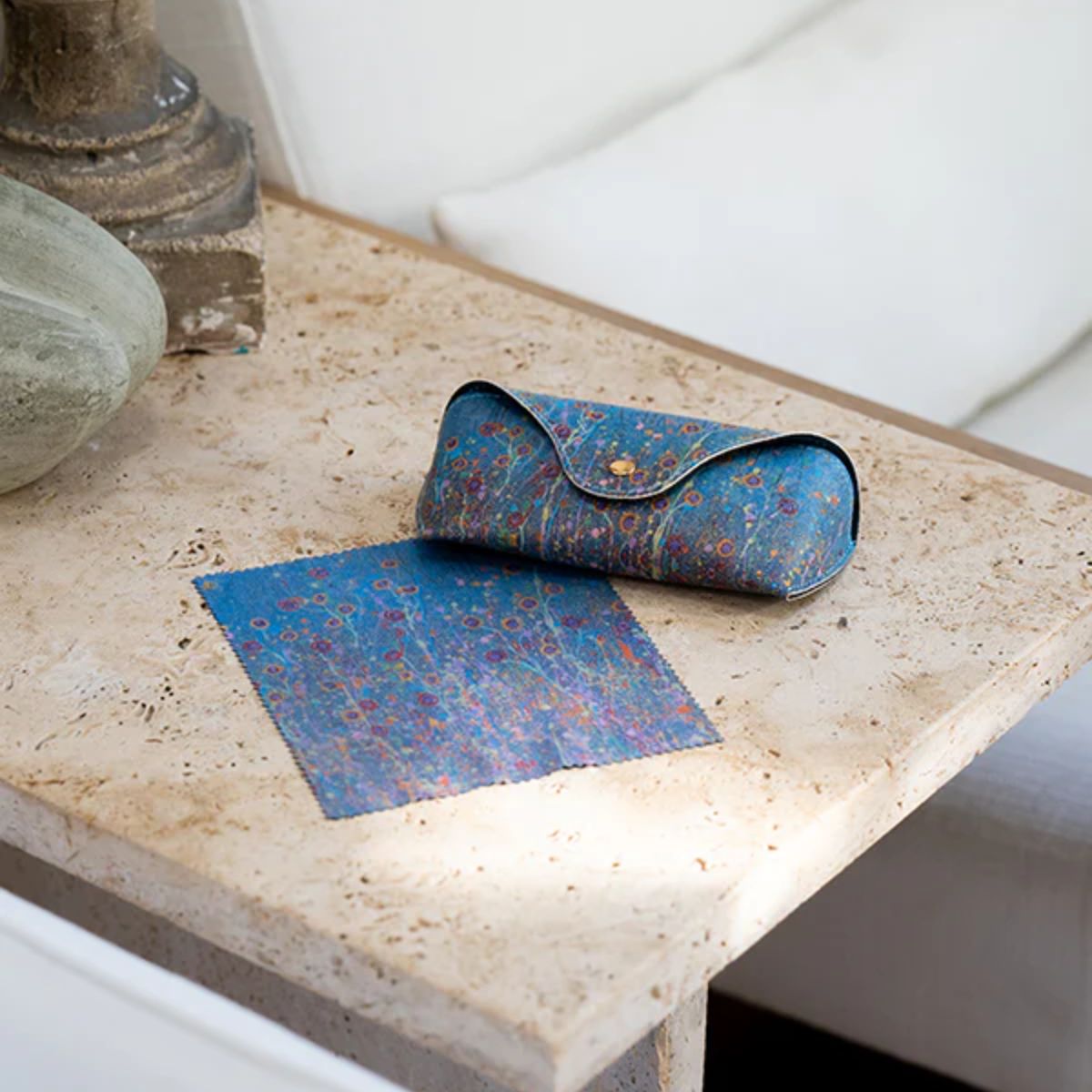 Blue patterned pouch and mat on a textured surface