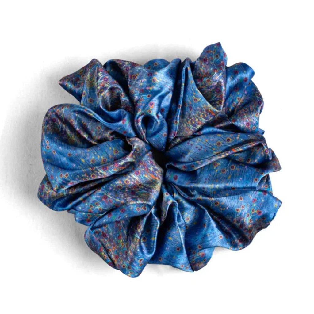 Blue floral patterned scrunchie on a white background