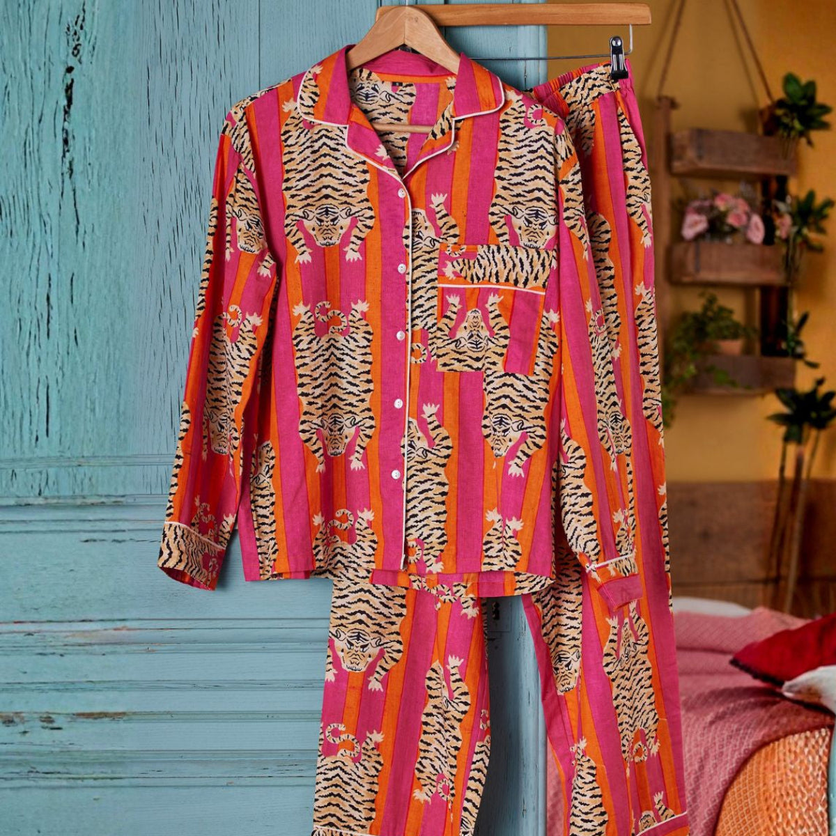 Colorful patterned shirt on a hanger against a blue wooden door.