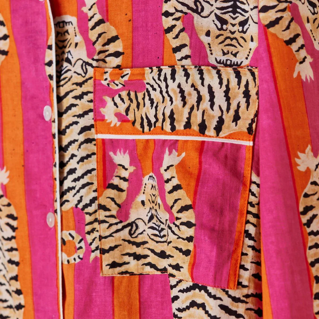 Fabric with tiger pattern on pink and orange striped background