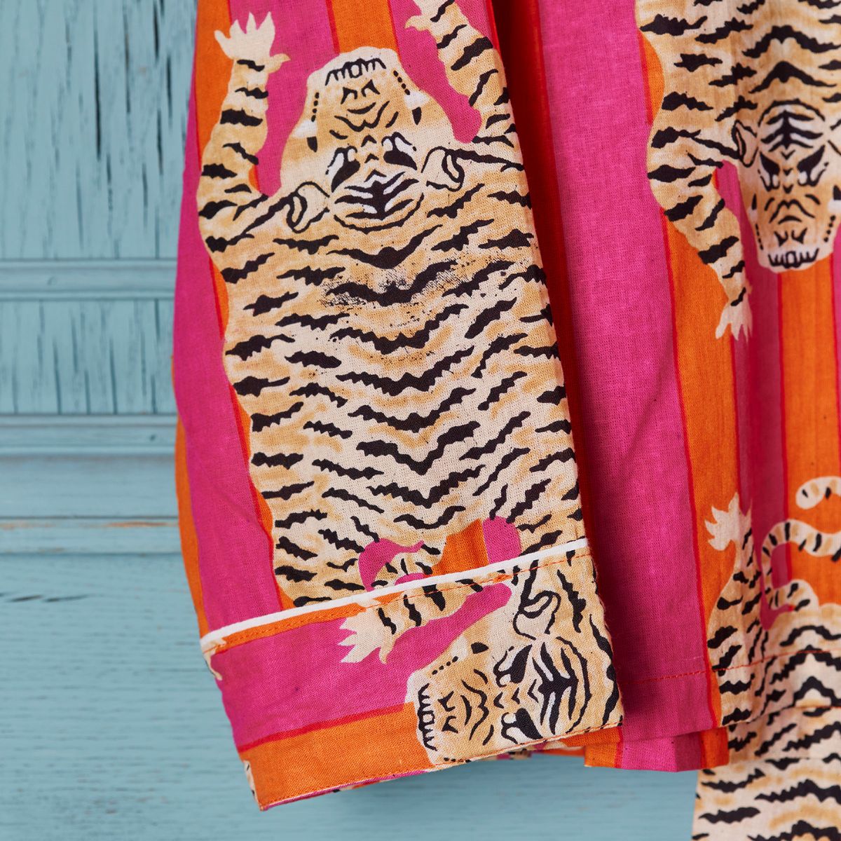 Sari with tiger design on a pink and orange background