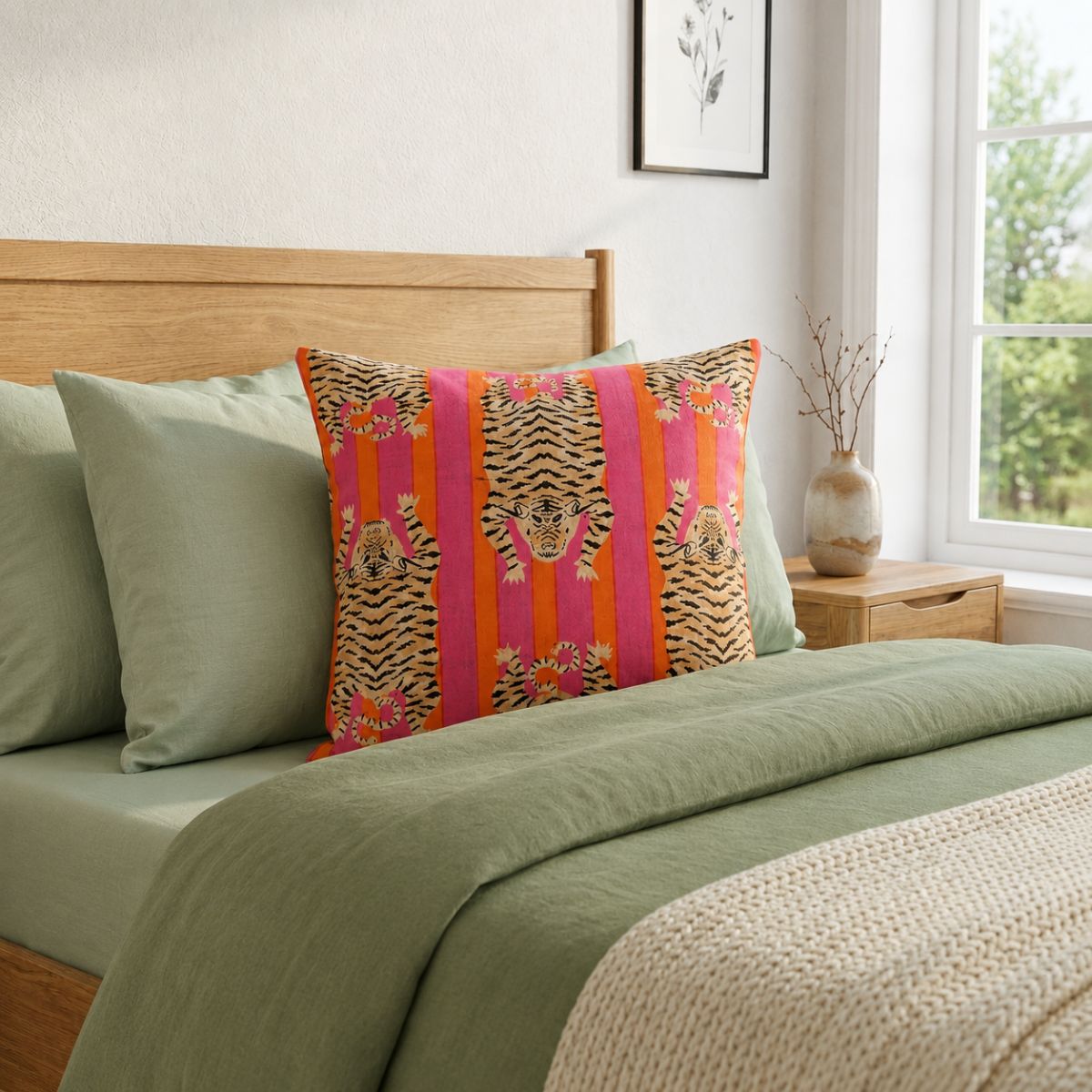 Bedroom with a bed featuring green bedding and a decorative pillow with tiger pattern.