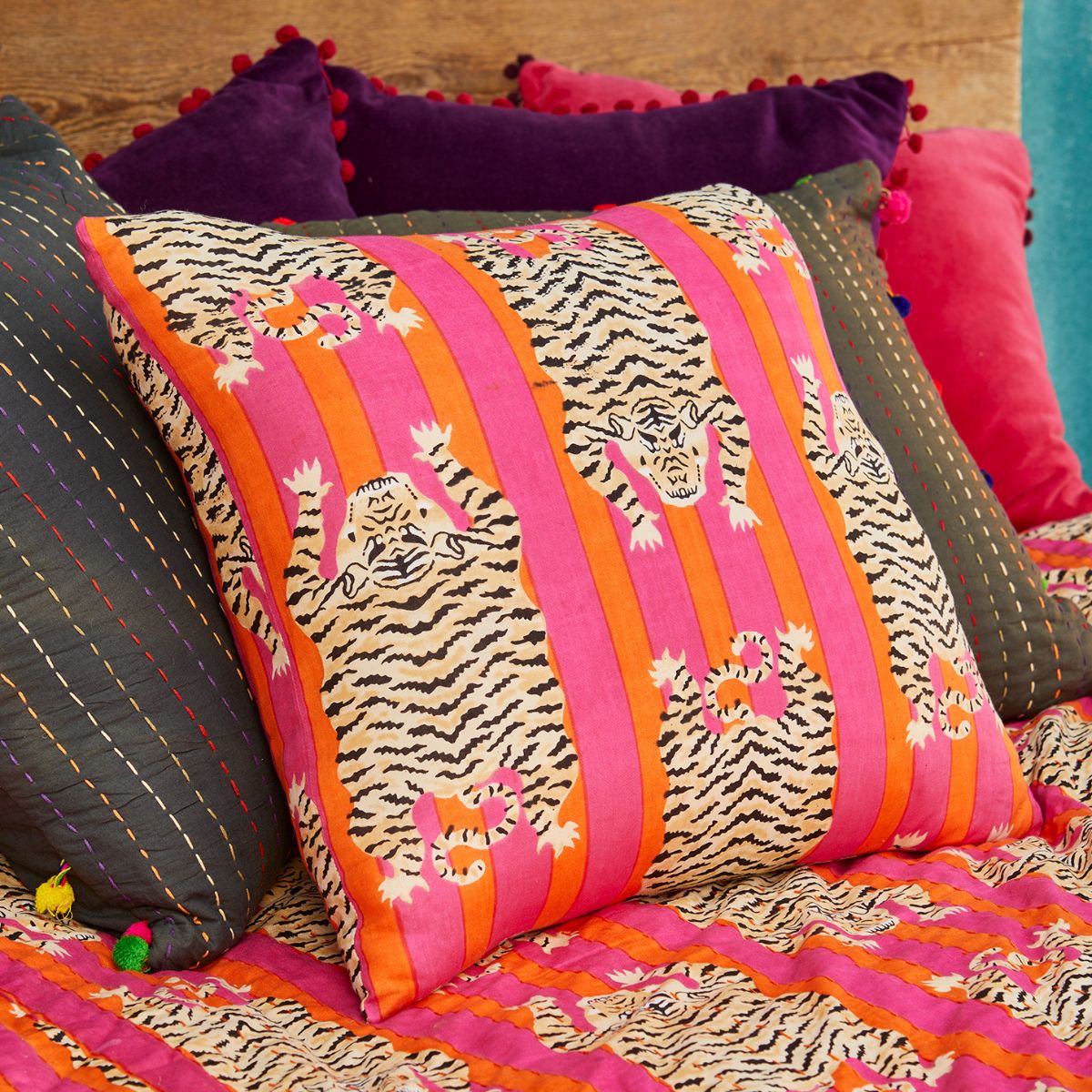Decorative pillow with tiger pattern on a colorful fabric background