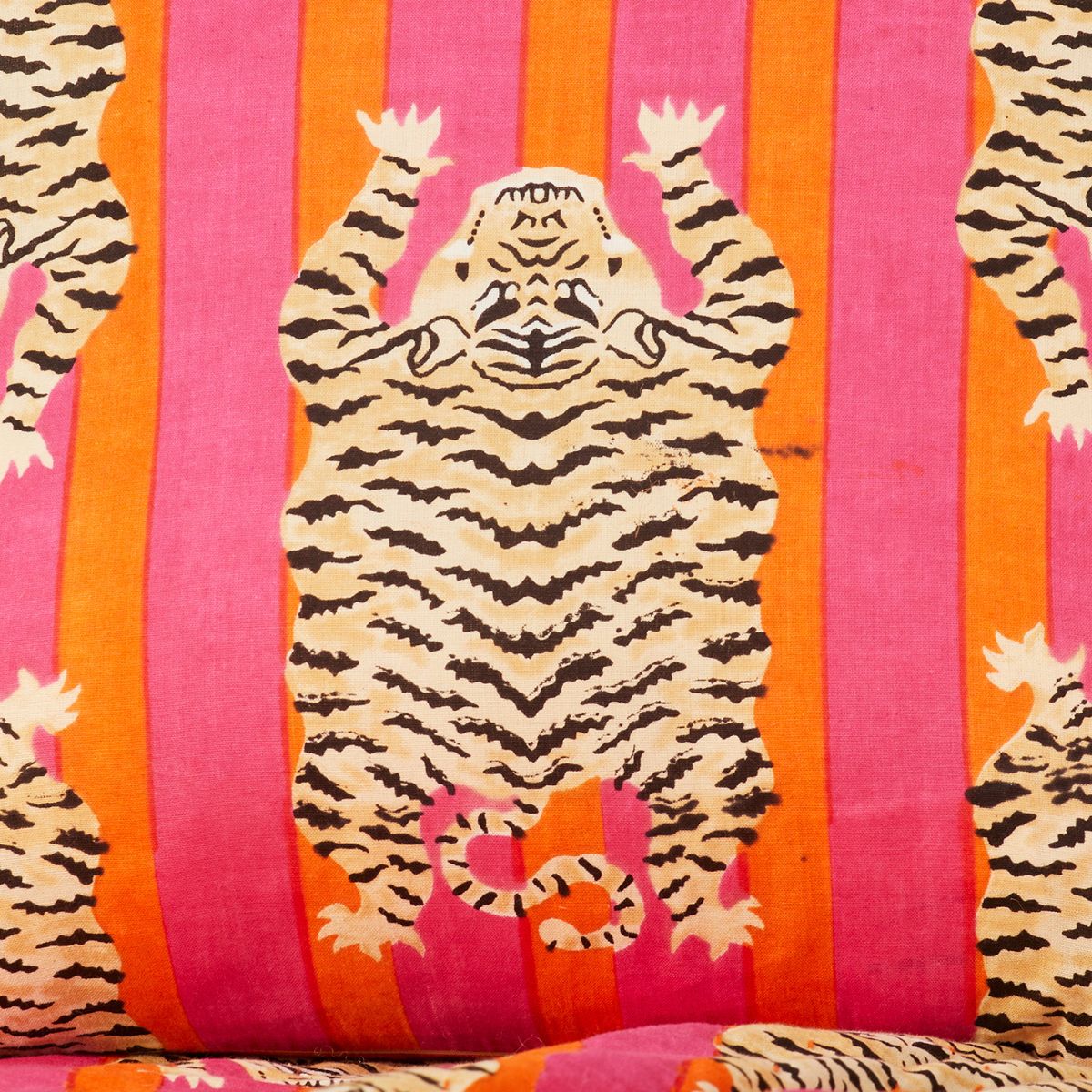 Tiger design on a fabric with pink and orange stripes