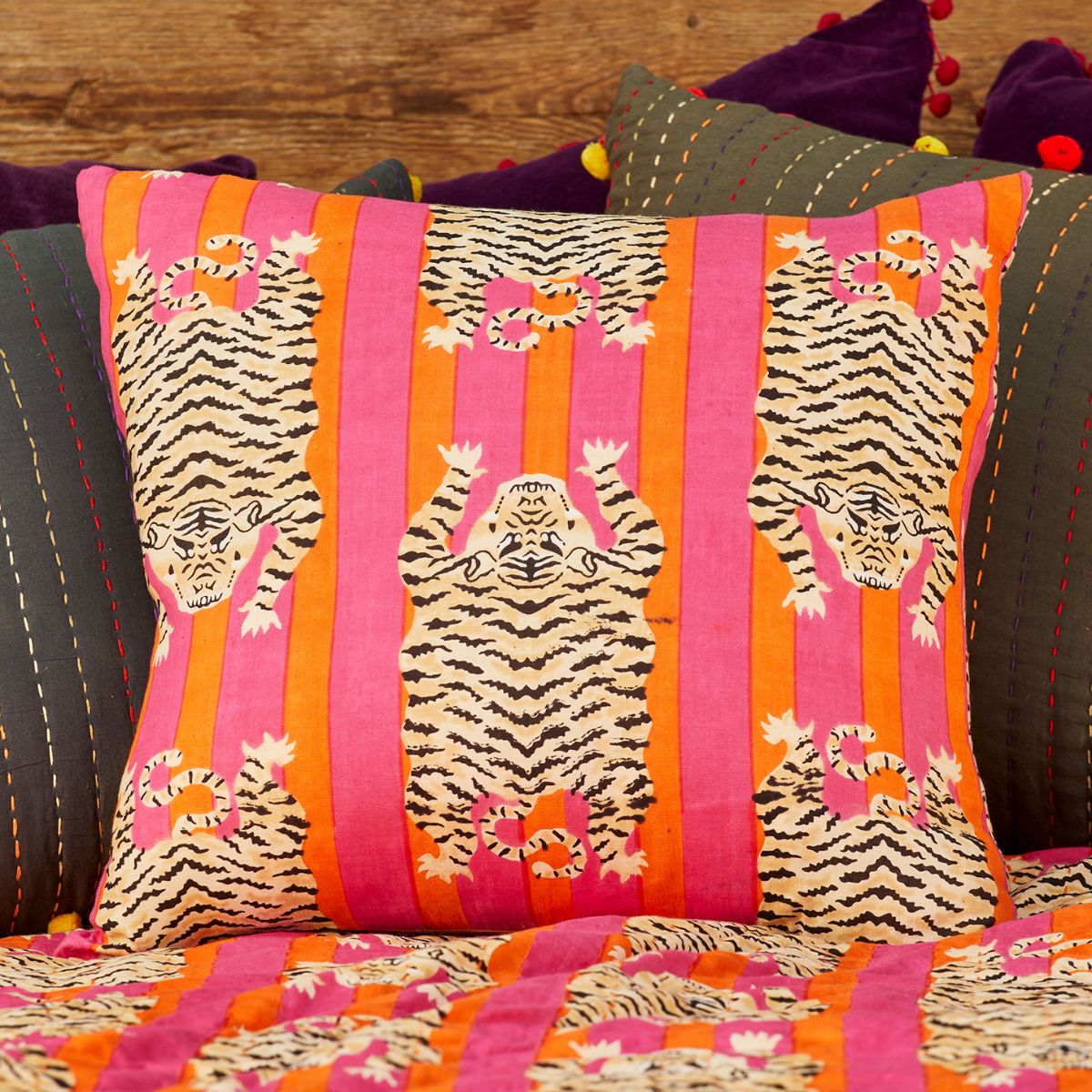 Decorative pillow with tiger pattern on a striped background