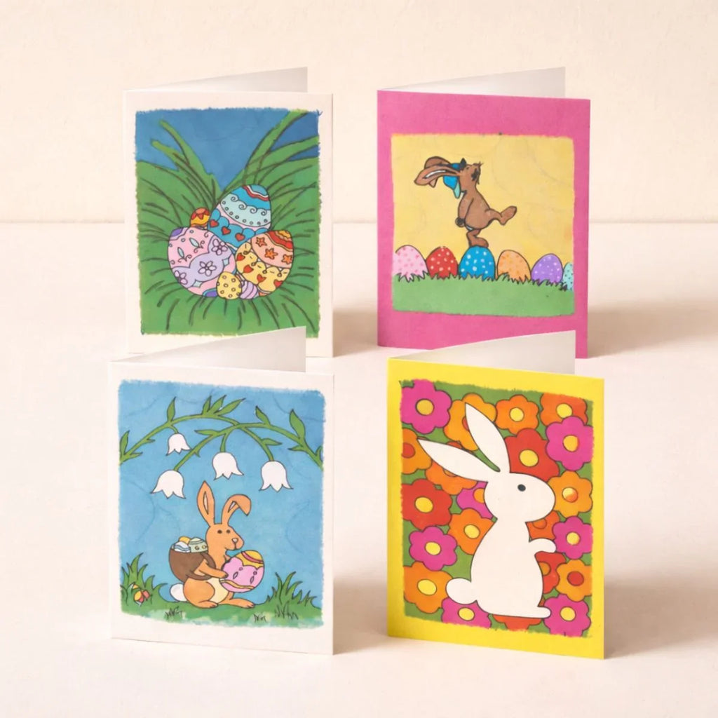 Four colorful Easter-themed greeting cards on a light background