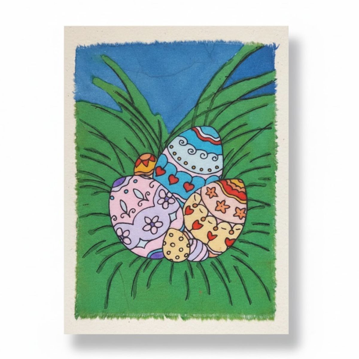 Colorful Easter eggs in a grassy field with a blue sky background