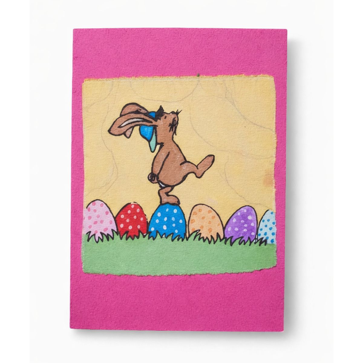 Card with a cartoon rabbit and Easter eggs on a pink border