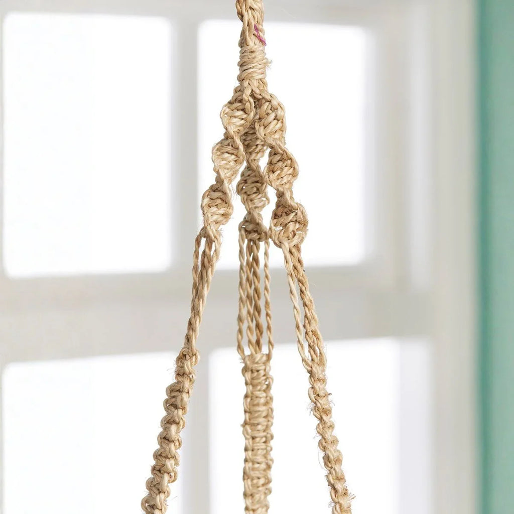 Close-up of a braided natural fiber rope against a blurred background