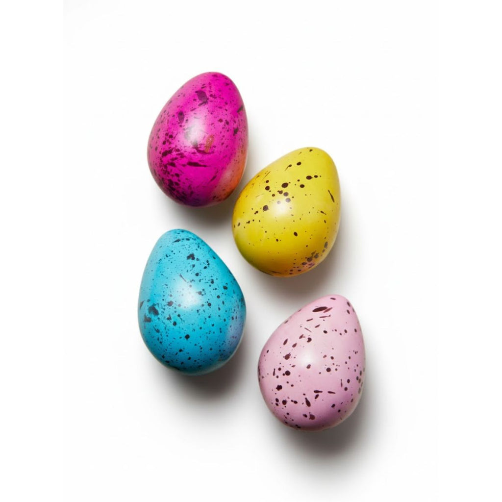 Four colorful speckled Easter eggs on a white background