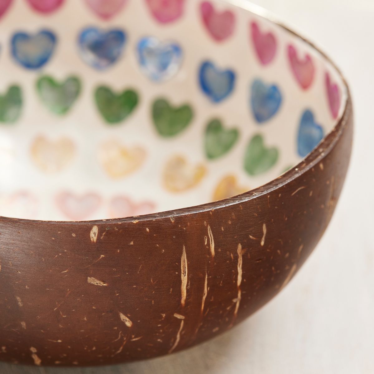 Coconut shell bowl with colorful heart pattern inside