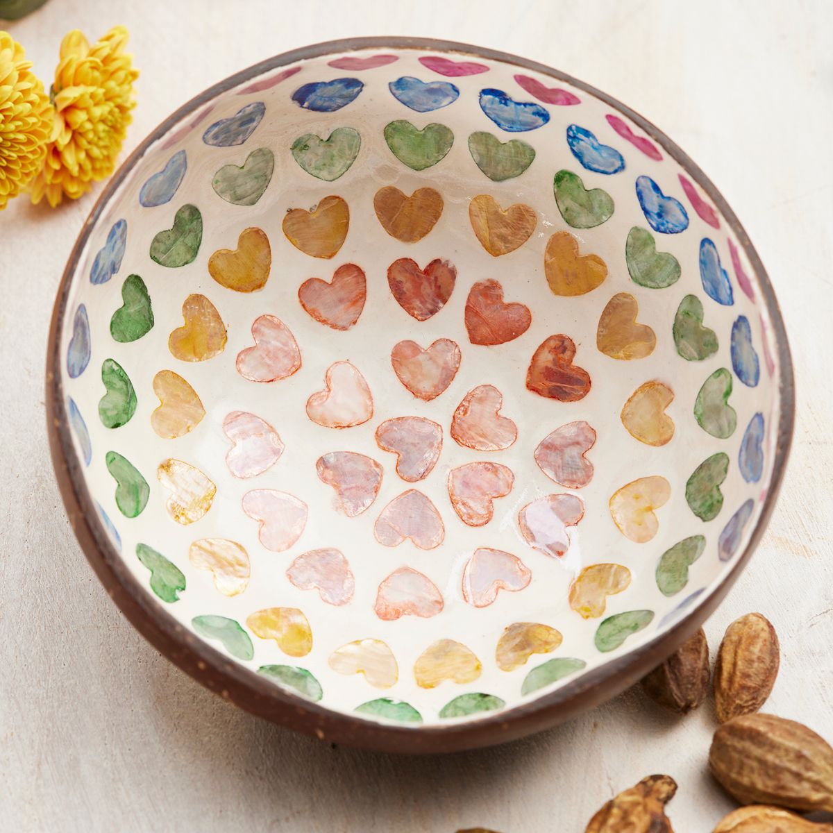 Ceramic bowl with colorful heart patterns on a light background