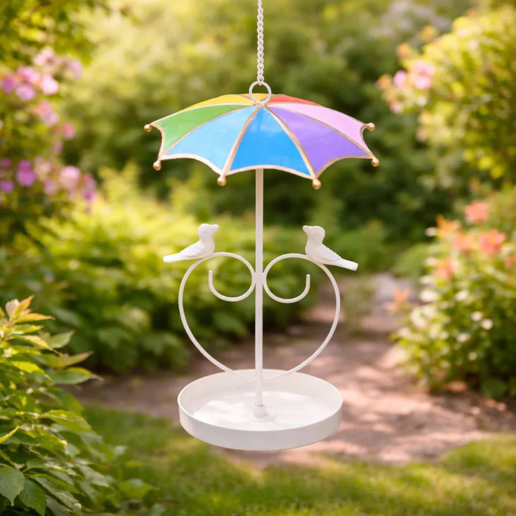 Decorative garden ornament with a colorful umbrella and bird design, set against a natural background.