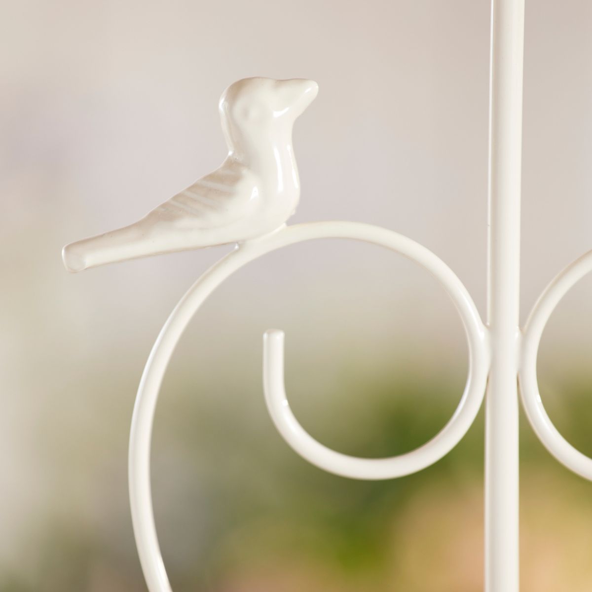 Decorative metal bird sculpture on a white background